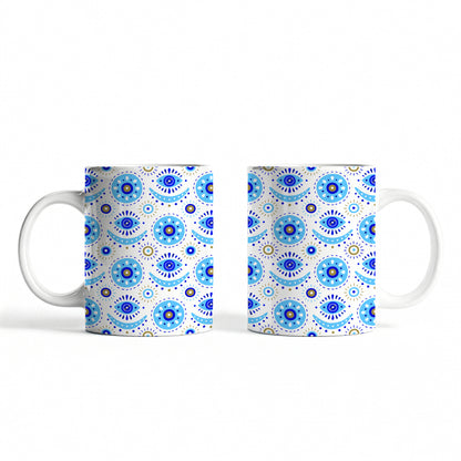 White ceramic mug featuring traditional evil eye design.