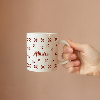 Hand holding personalized ceramic mug with desi design