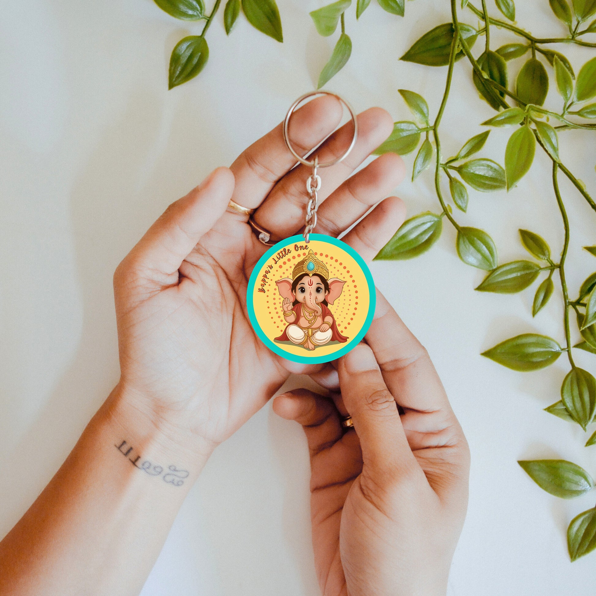 Hand holding double sided keychain