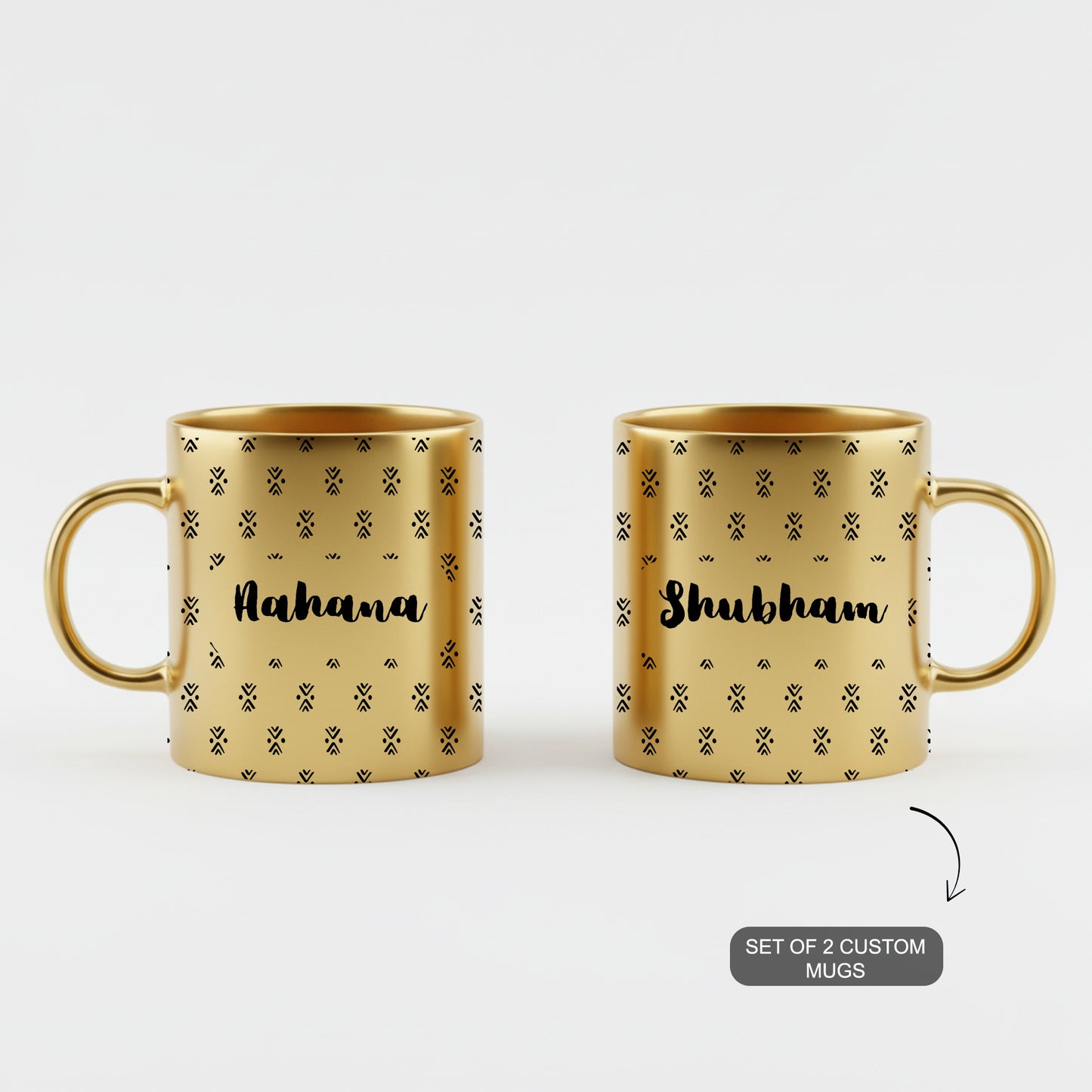 Pair of golden custom mugs with ethnic designs and personalized names.