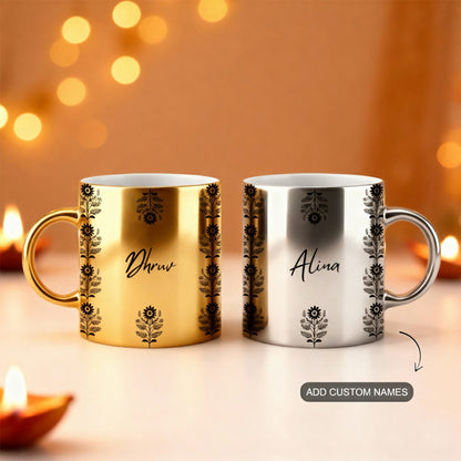 Two personalized mugs, one gold and one silver, with decorative patterns and custom names