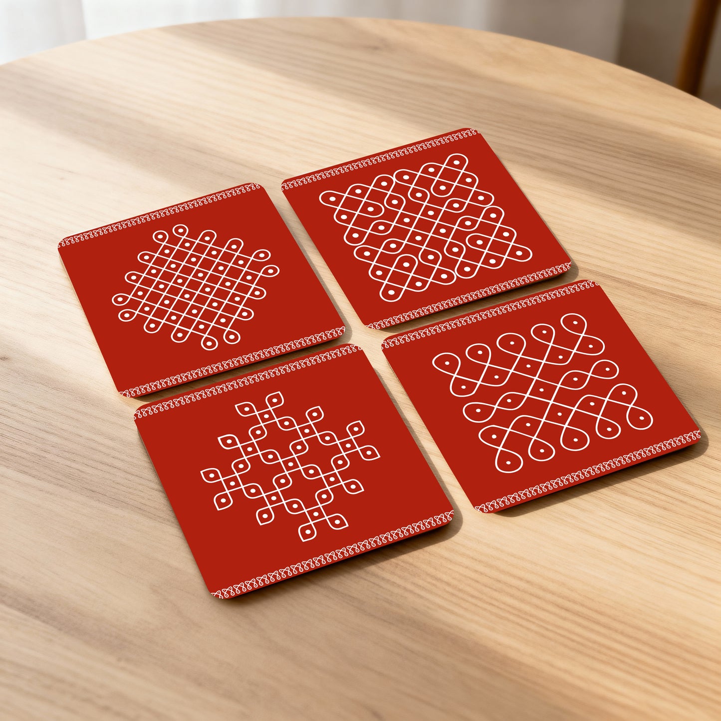 Set of 4 coasters with traditional kolam designs.
