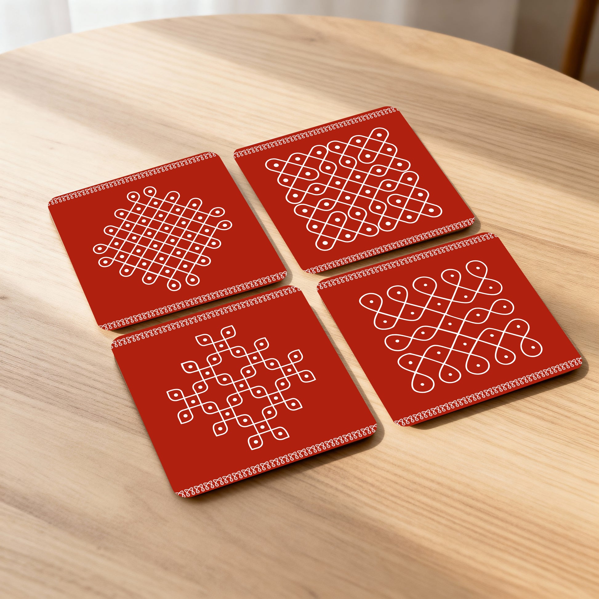 Set of 4 coasters with traditional kolam designs.