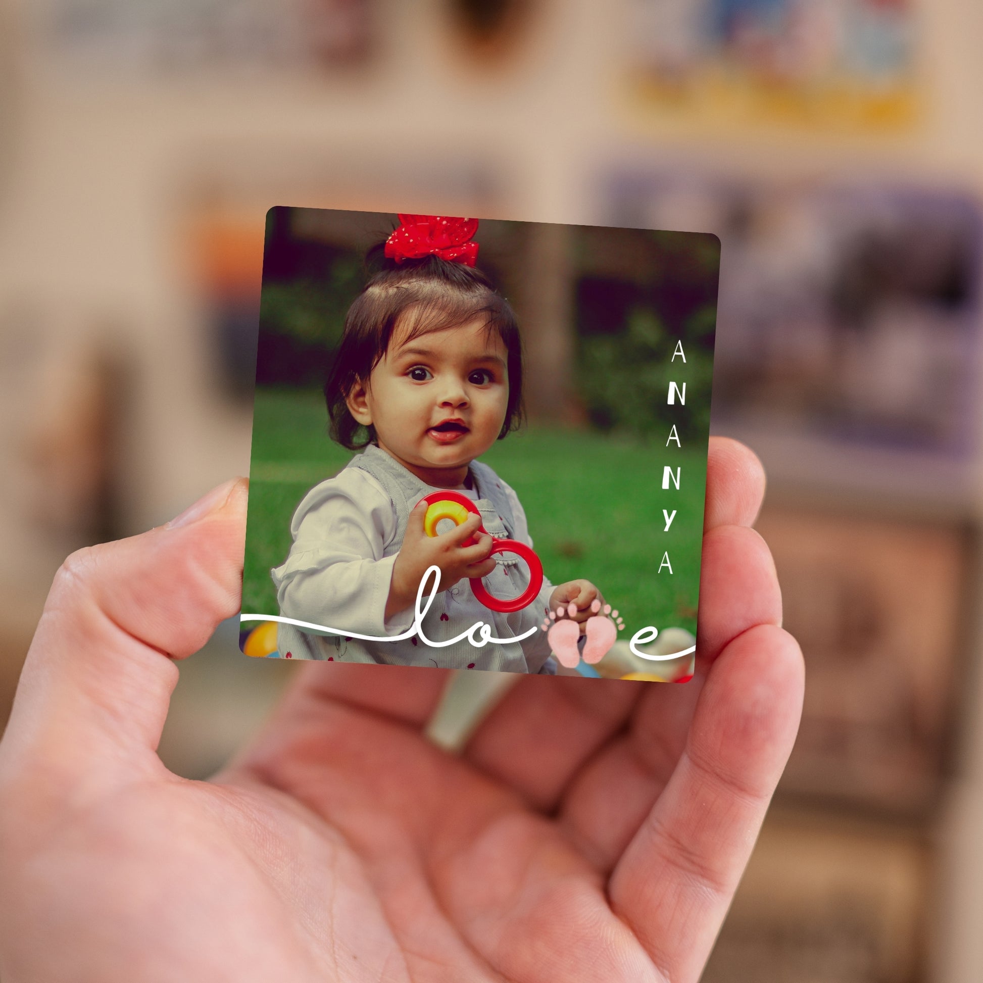 Handheld Little Wonder personalized baby photo magnet.